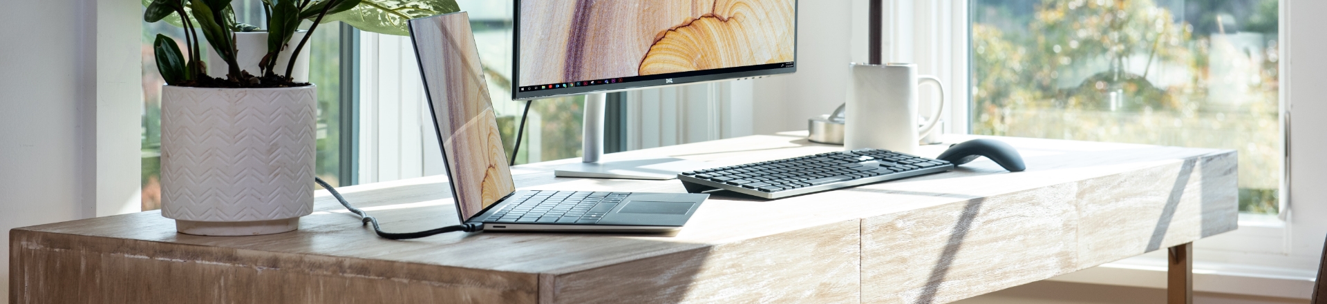 desk with desktop computer and laptop