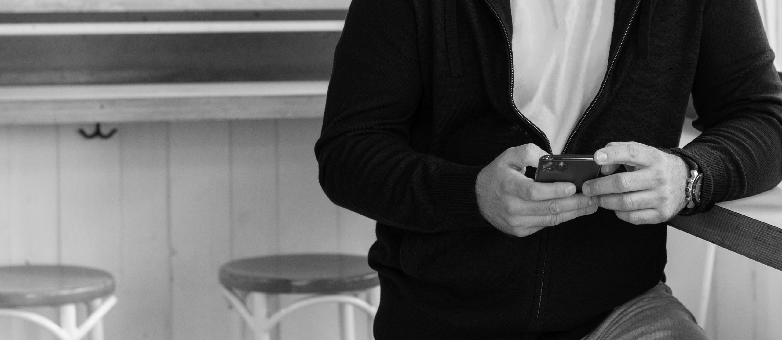 man using phone in black and whiteimage