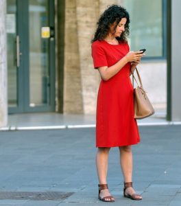 Women in red dress on cell phone