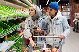 couple in grocery store on cellphone