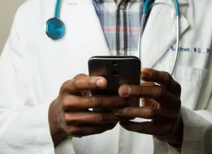 Doctor communicating with office staff via SMS.