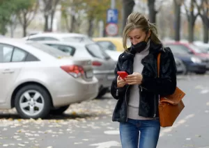 women on cellphone in parking lot