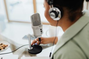 person talking into microphone for radio station