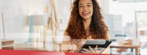 Women holding ipad smiling